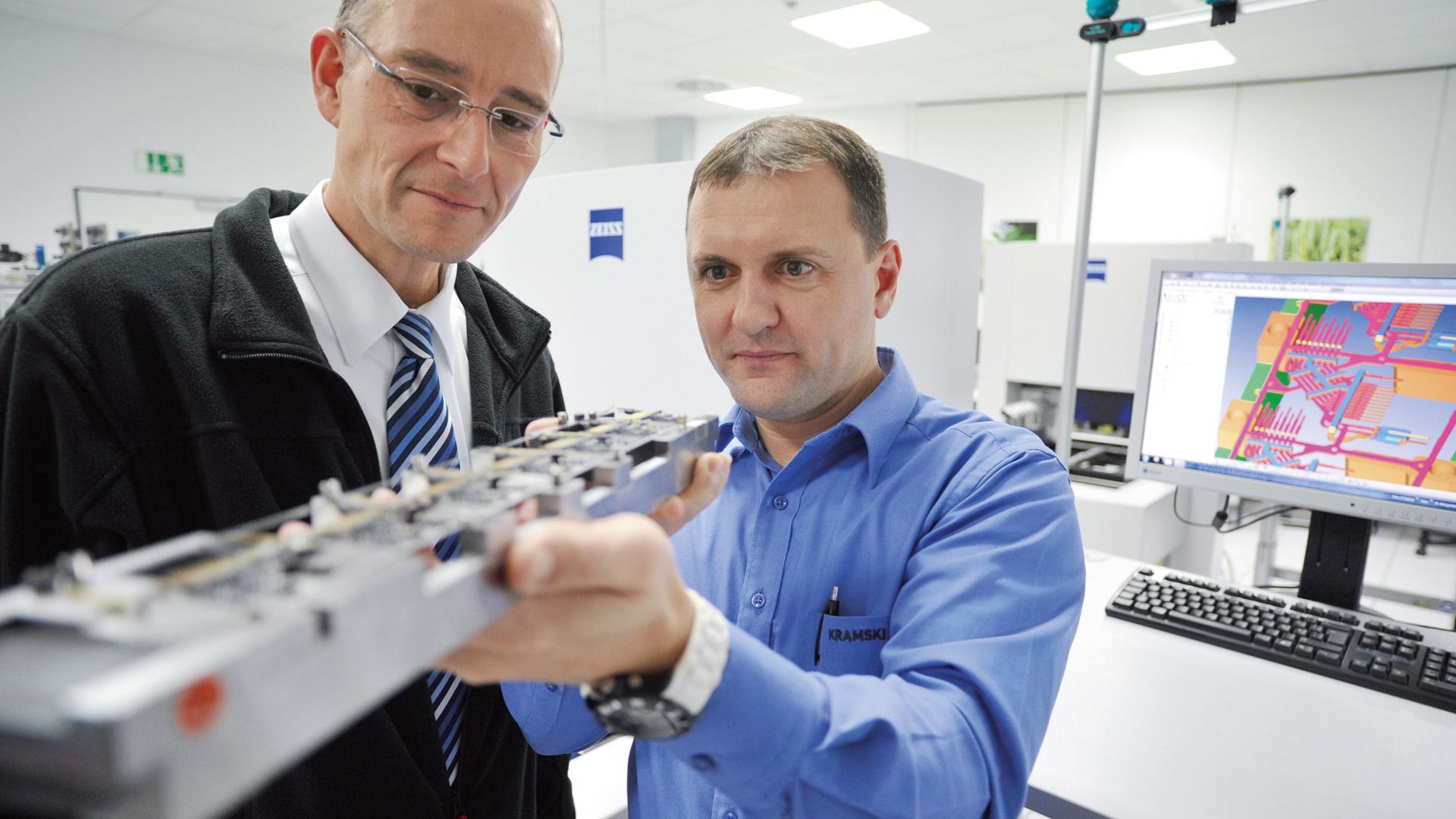 Work in a measuring lab must be fast and precise. Team supervisor Mathias Schlegel (left) and his colleague Waldemar Fust are supported by multiple ZEISS measuring machines
