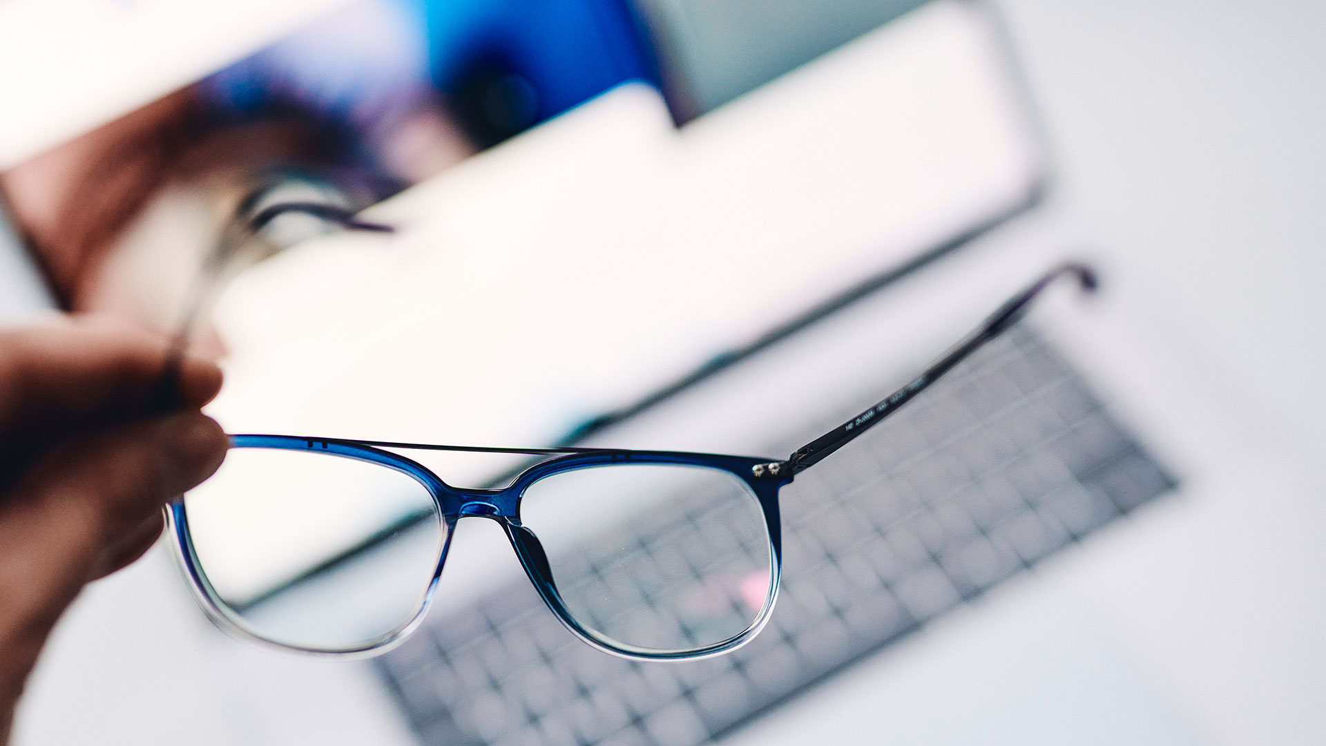 ZEISS Digital SmartLife lenses in a dark blue eyeglass frame on white background