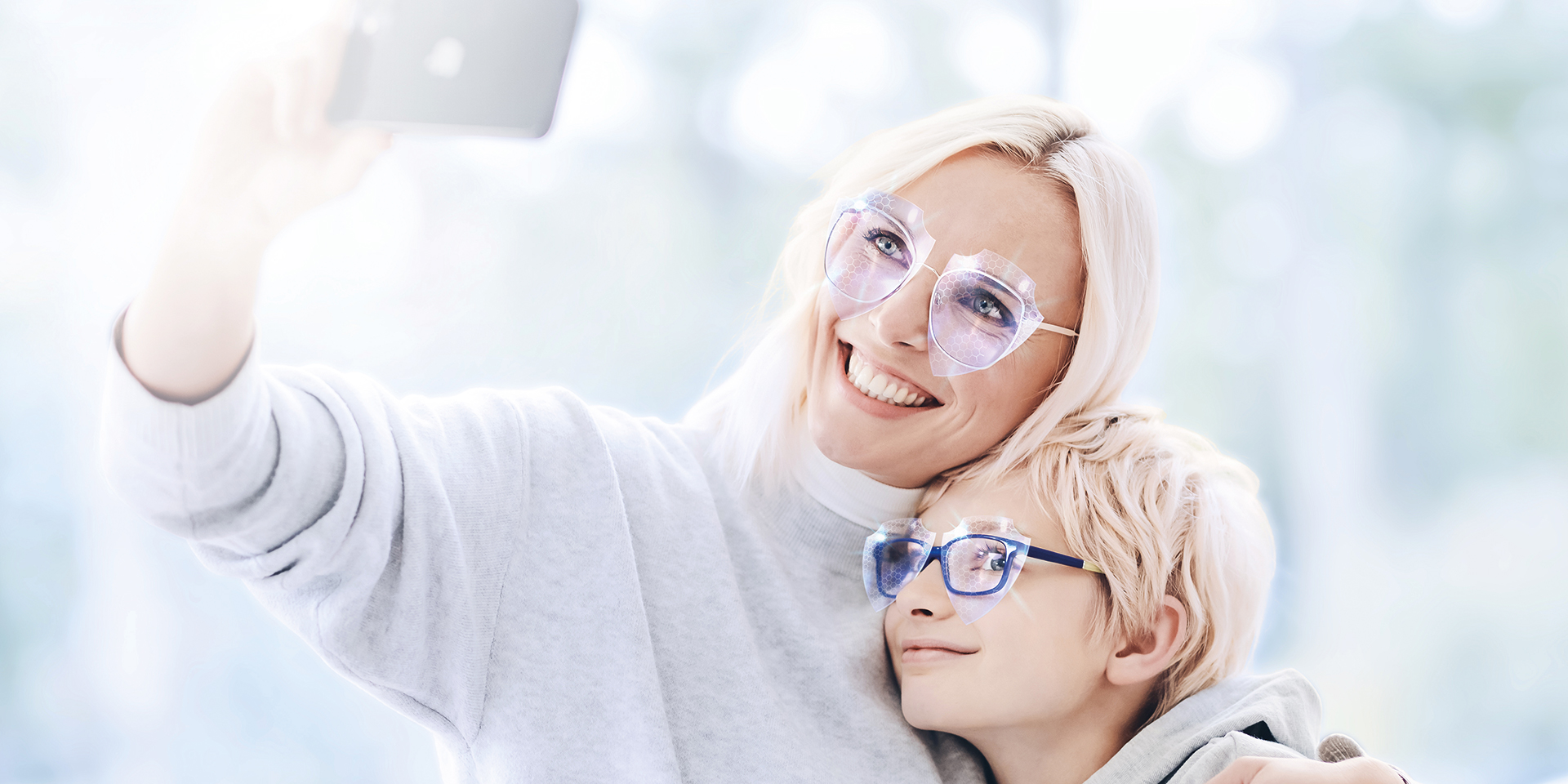 Blonde woman taking a selfie with her boy. Both wear glasses with AntiVirus coating.
