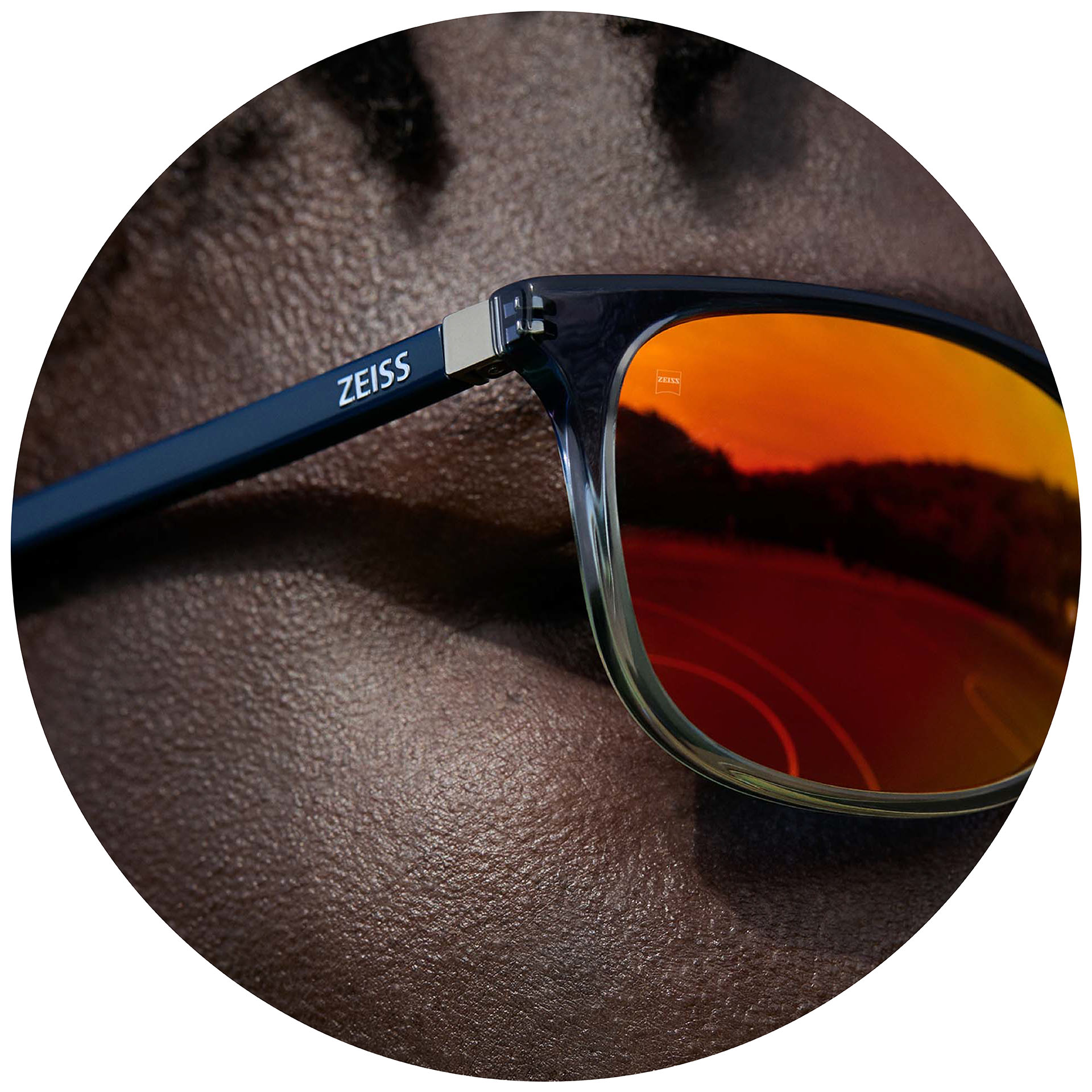 A man wearing ZEISS Eyewear with prescription sunglass lenses with an organge mirror coating.