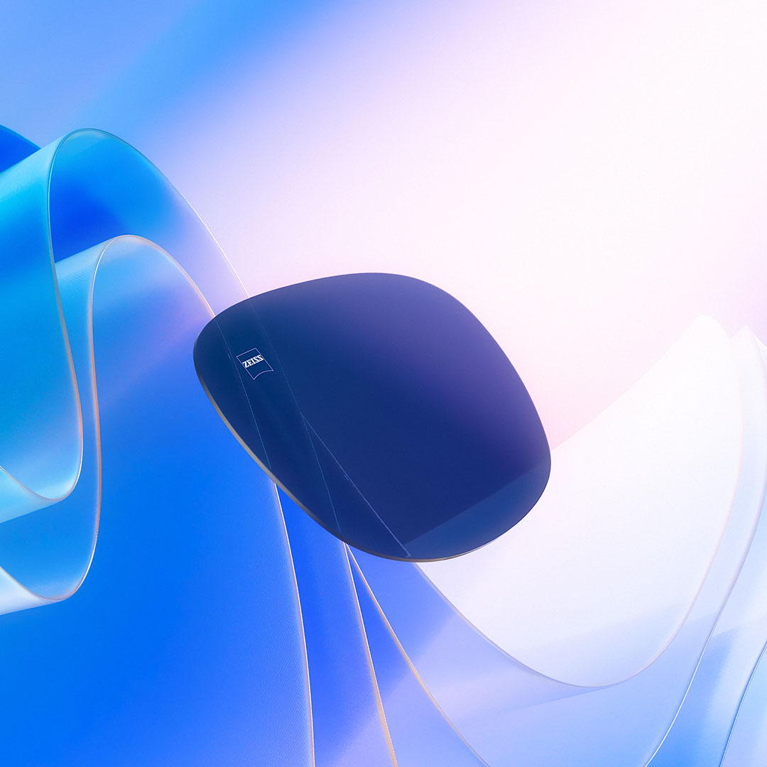 A CGI representation of a tinted lens is shown floating towards sunlight, illustrating its UV ray-blocking capabilities
