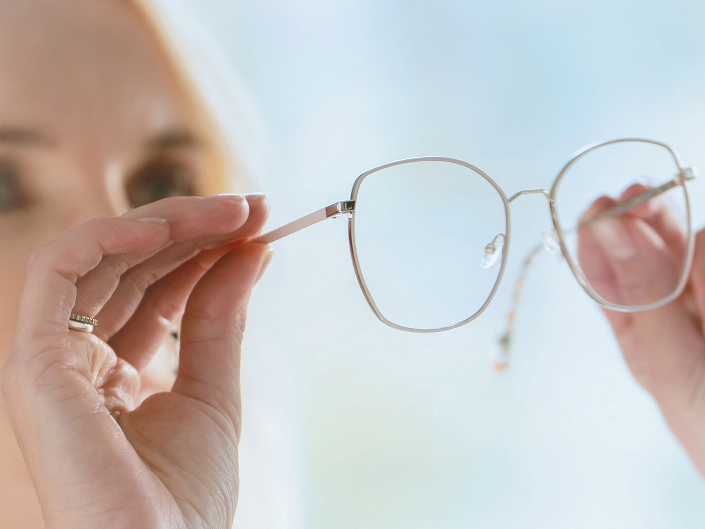 A woman observing the inner side of the glasses